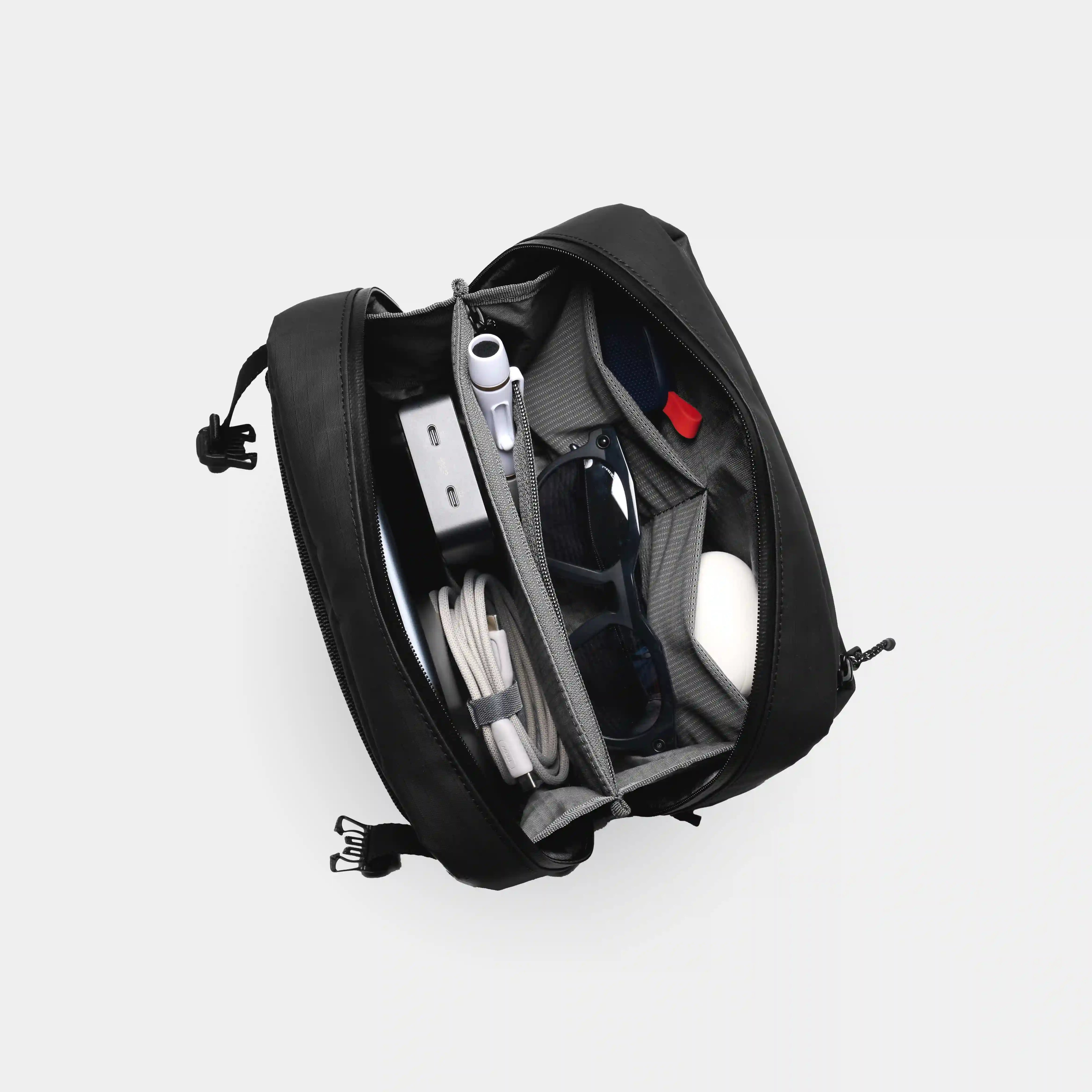 Black backpack with compartments on a white background