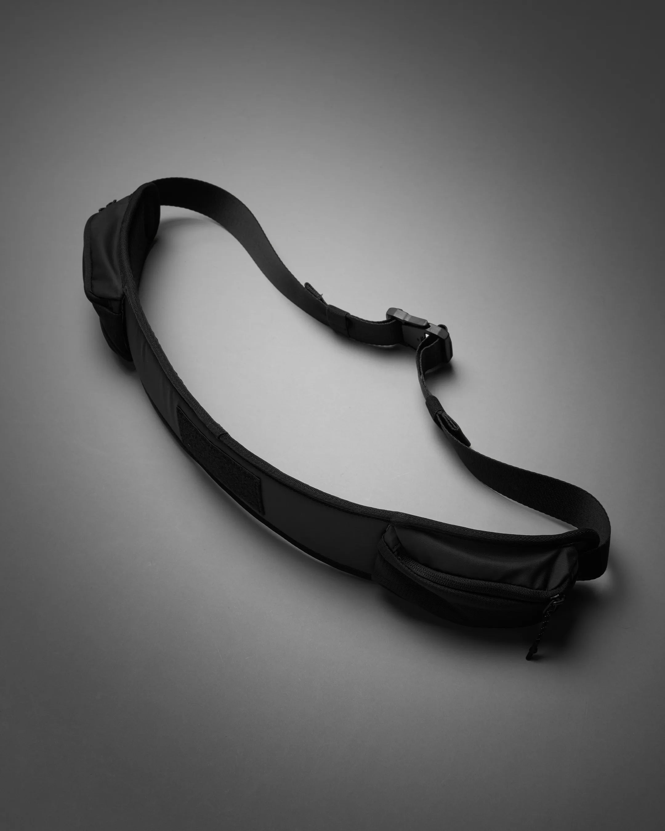Black waist bag on a gray background