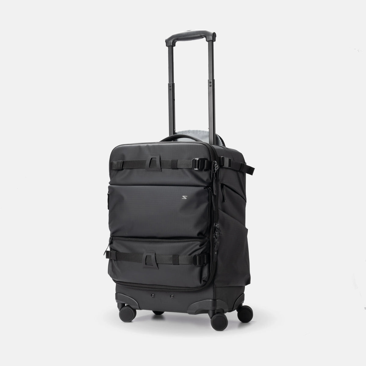 A black rolling suitcase with an extended telescoping handle, spinner wheels, and multiple compression straps on the front, shown against a light gray studio background.