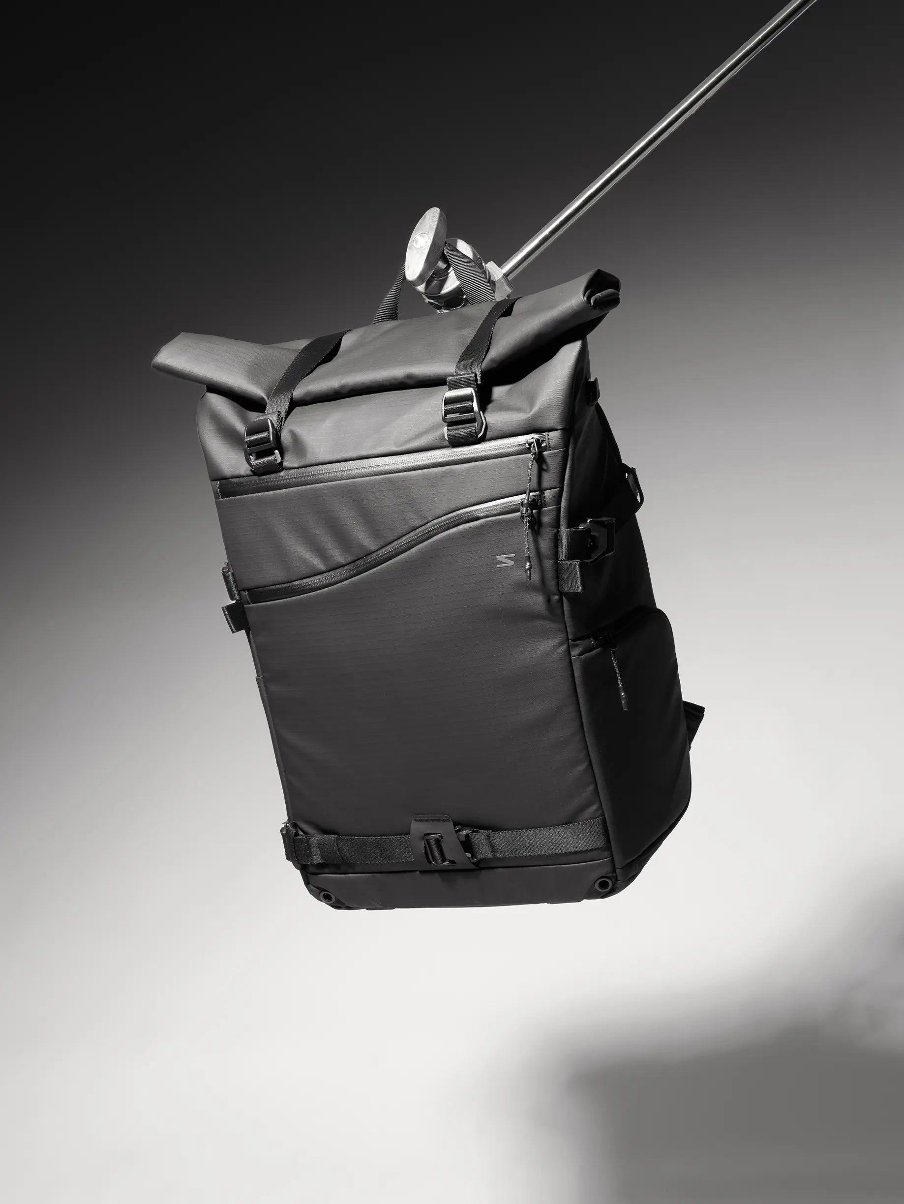 Black backpack on a gradient gray background