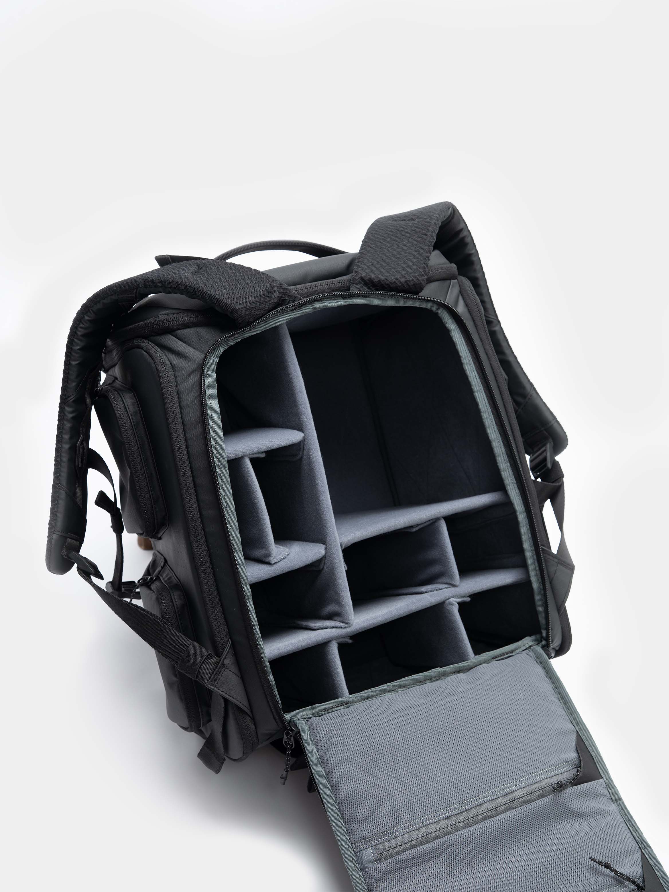 Black backpack with compartments on a white background