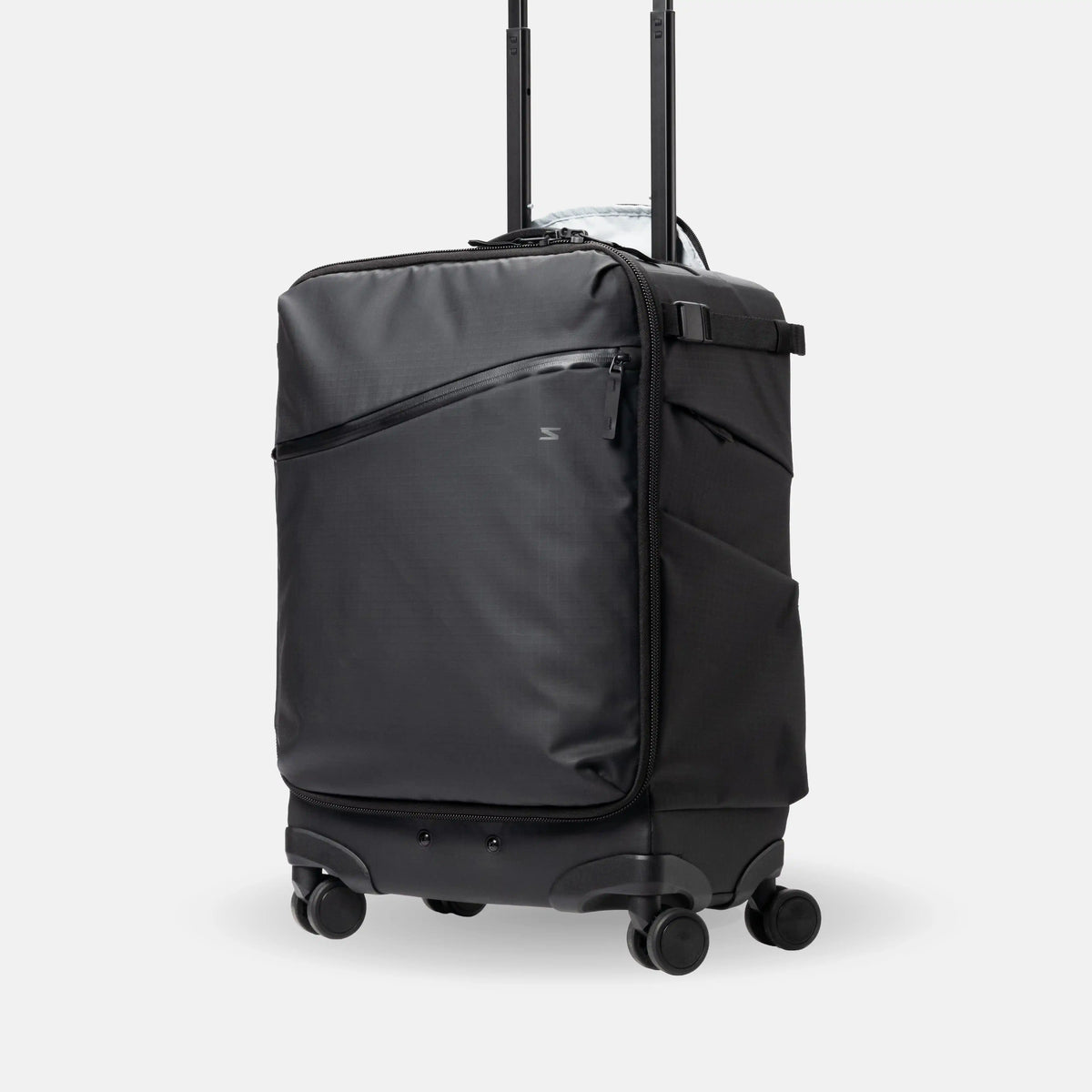 A black rolling suitcase with an extended telescoping handle, shown on a light gray studio background. The suitcase features a diagonal zippered pocket on the front, a side pocket, and four spinner wheels.