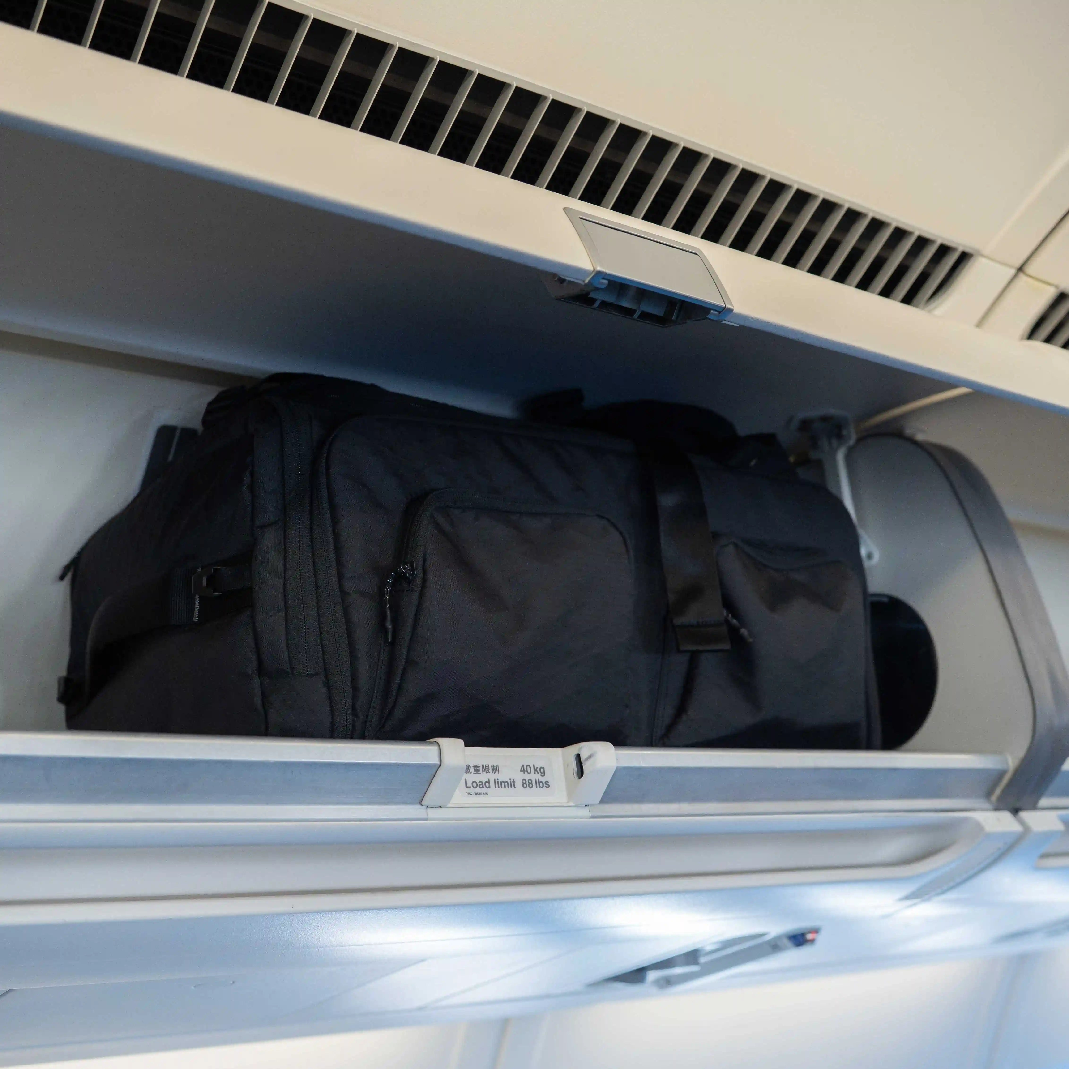Sakk Pack V2 stored in airplane overhead cabin. Fits cinema cameras, laptop, and travel essentials.