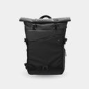Black roll-top backpack on a light gray background