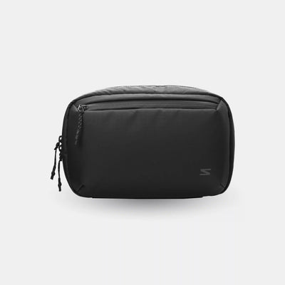 Black toiletry bag on a light gray background