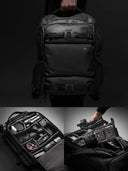 Black camera backpack with compartments and gear on a dark background