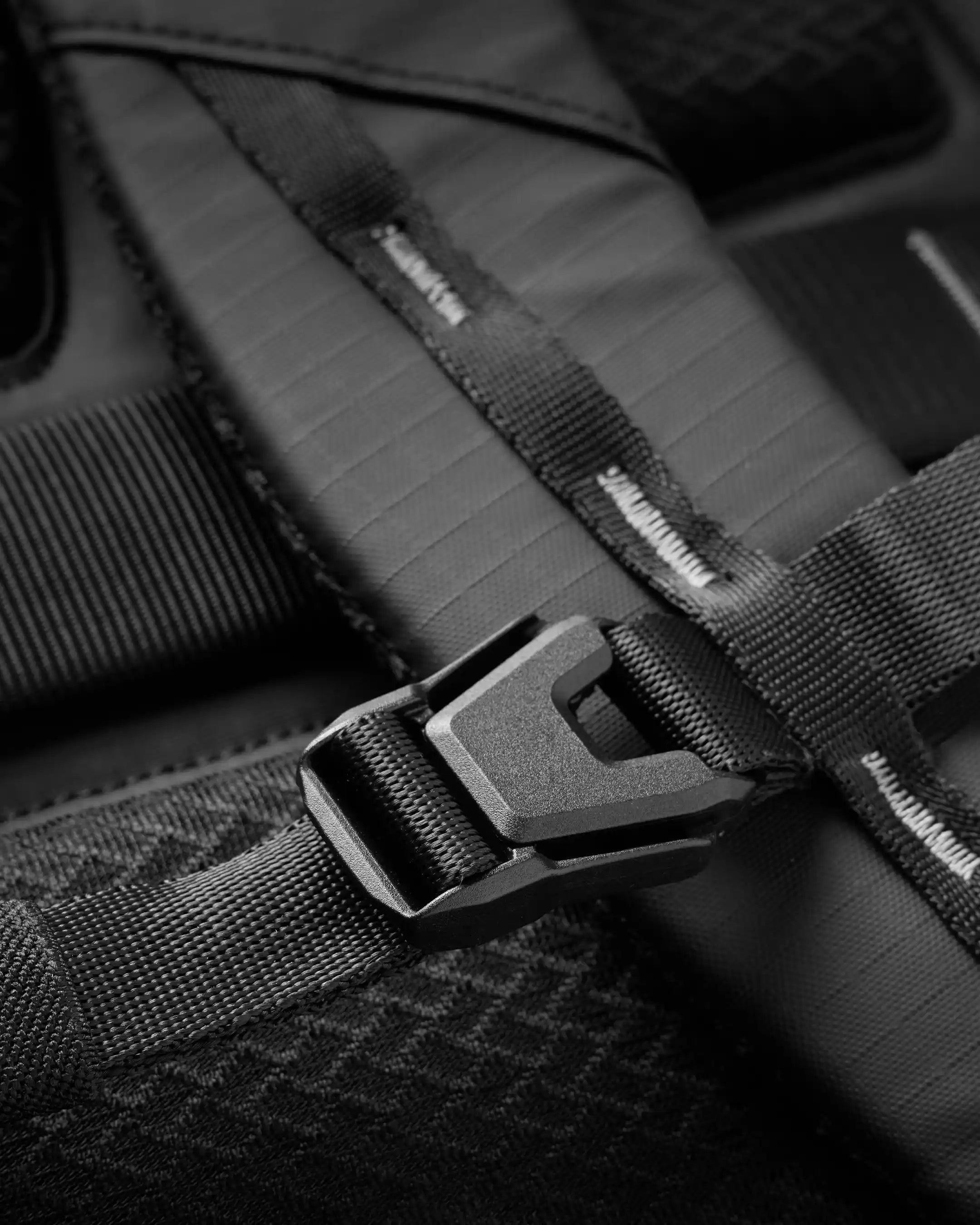Close-up of a black seat belt buckle on a vehicle seat.