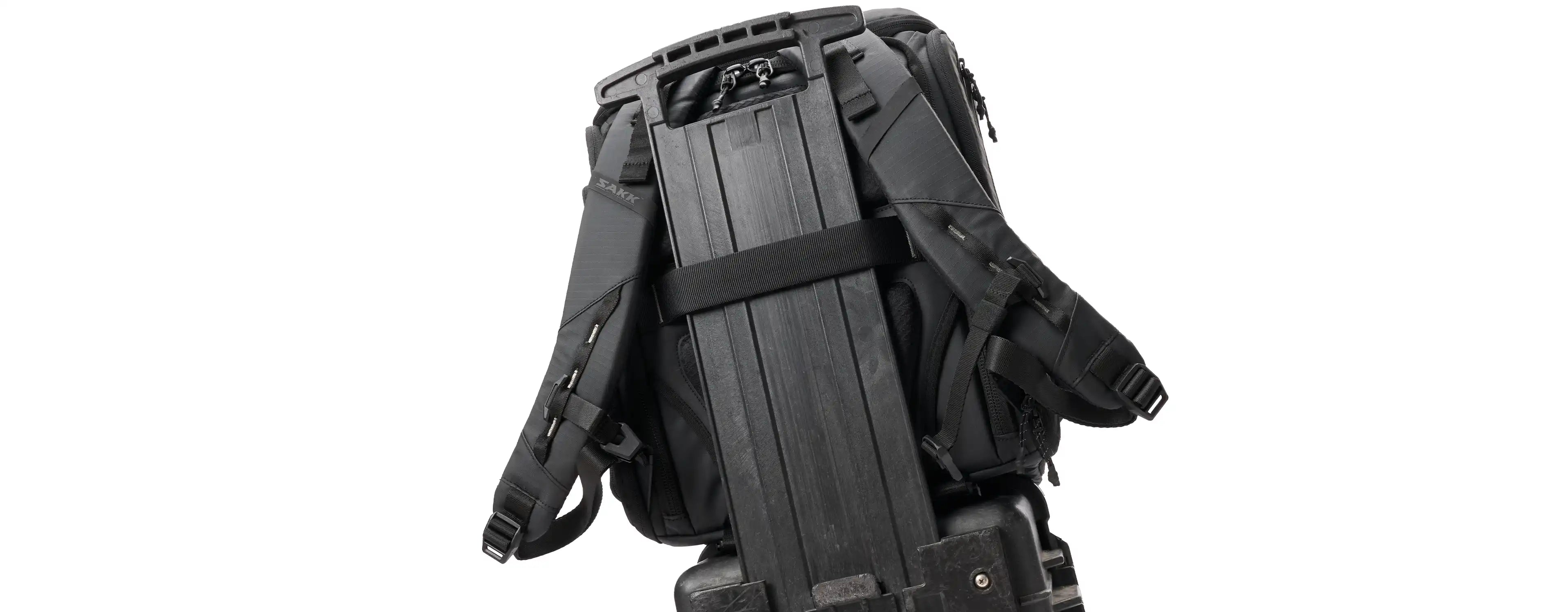 Black tactical backpack with multiple compartments on a white background