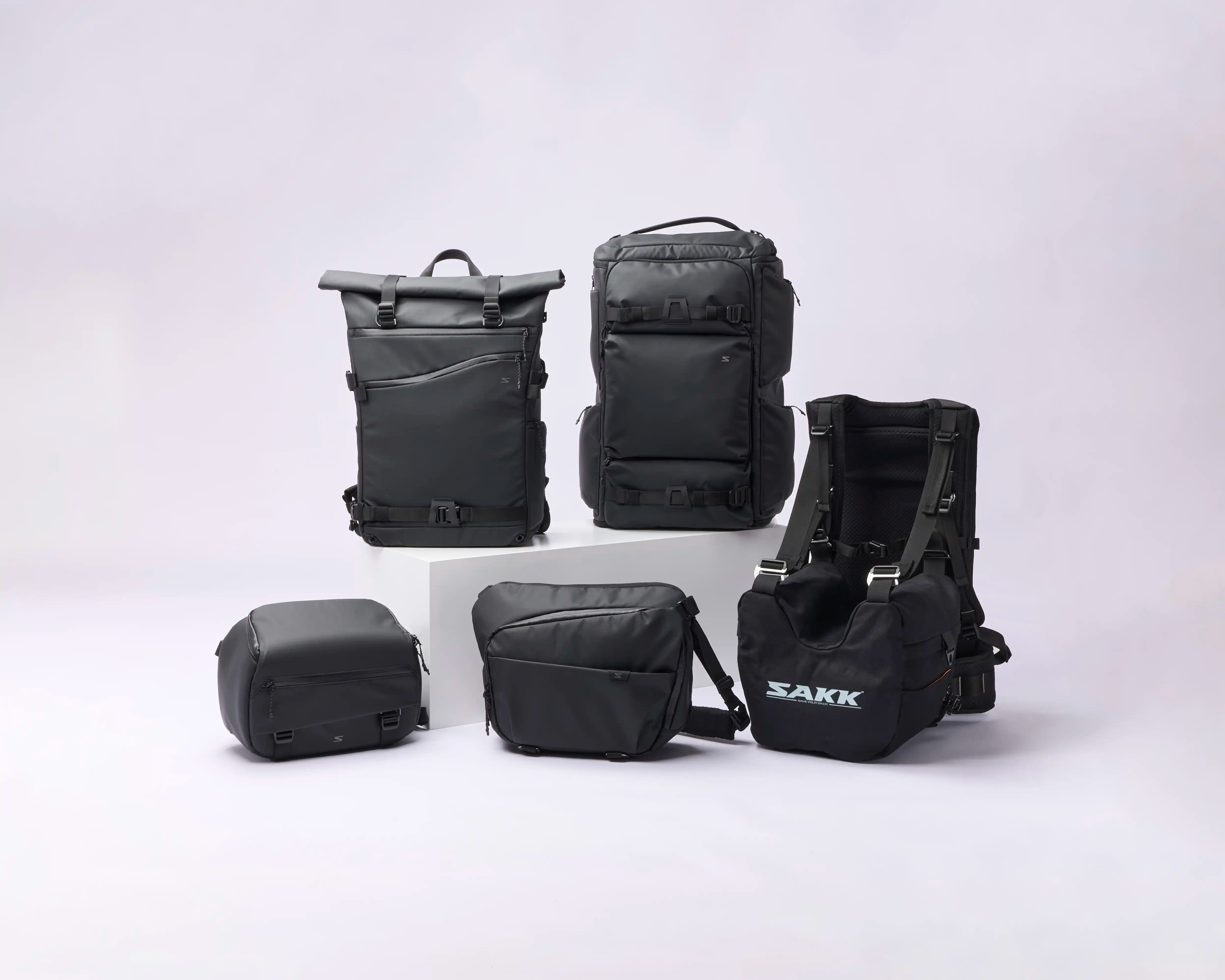 Collection of black bags with visible brand name on a white background