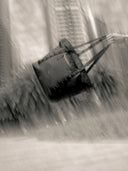Black bulldozer in a blurred, water-like background