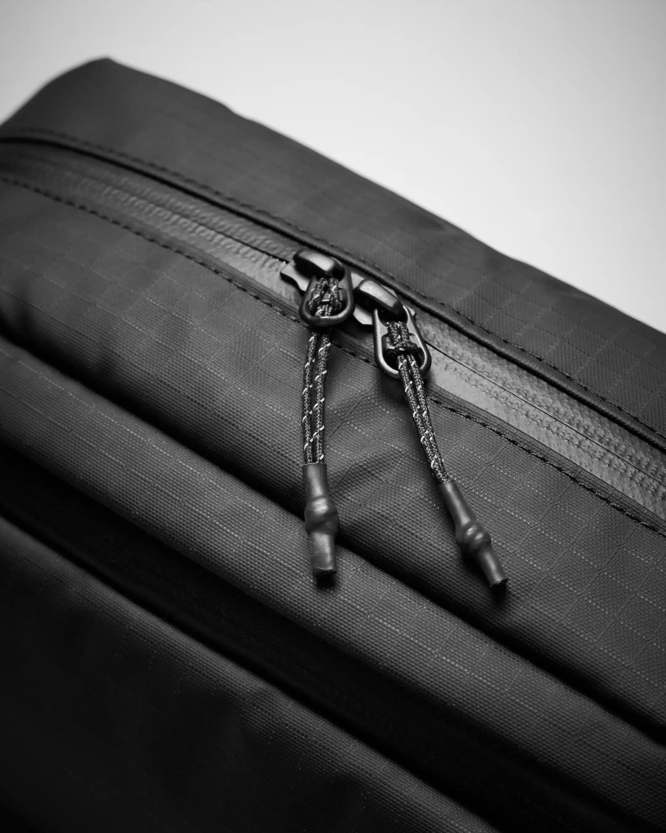 Close-up of a black zipper on a textured surface