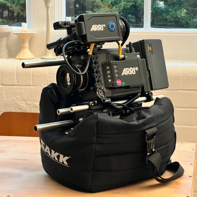 Versatile camera saddle for location work, set on rocks, car hoods, or flat ground.