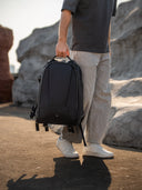Lightweight 28L camera backpack with padded compartments for lenses, tripod, and daily gear.