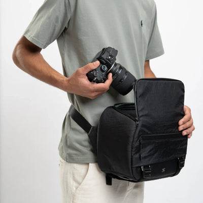Lightweight camera sling for street shoots or drone setups. Waterproof with secure pockets.