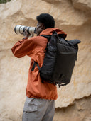 Rolltop backpack for photographers. Holds camera, lenses, and accessories with quick-access side and front pockets.