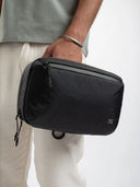 Portable tech organizer pouch with interior compartments for gadgets and essentials.
