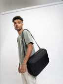 Slim laptop briefcase with structured design and hidden backpack straps—smart look with gear protection.