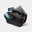 Slim sling bag holds travel tech accessories. Designed to fit inside any carry-on or tote.